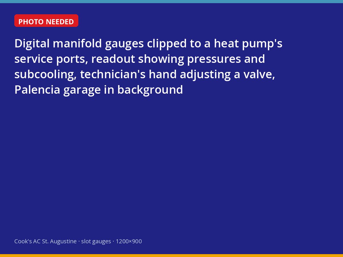 Digital gauges reading refrigerant pressures on a heat pump during a maintenance visit